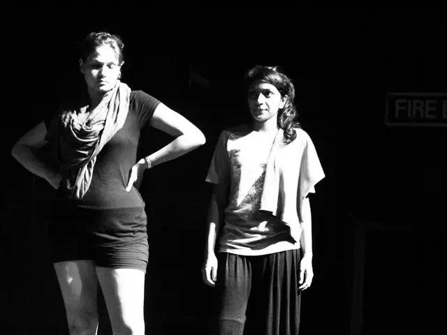 In this image we can see women standing. In the background there is a door.