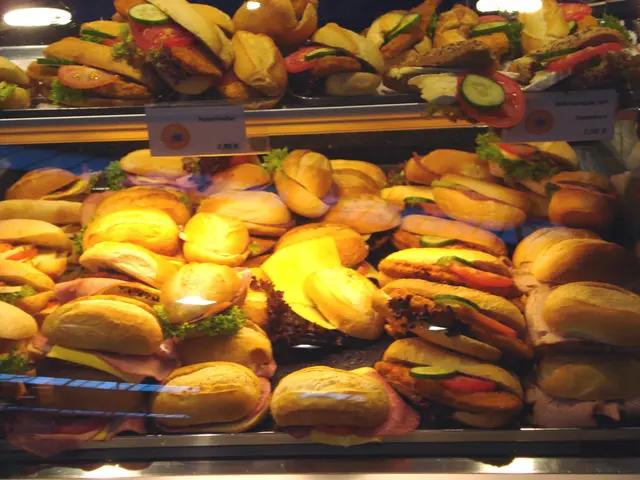 In this image we can see many burgers places in racks.