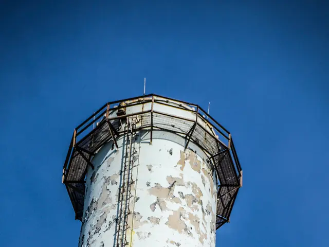 In this image there is a big tanker with iron ladder and fence at the top.
