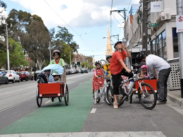 This picture is clicked on a road. There are people on the road. The woman to the center is riding...