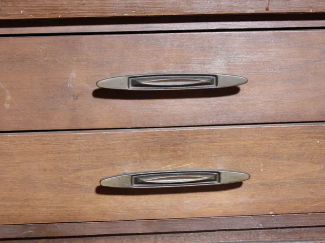 In this image we can see a cupboard on which two handles are placed.
