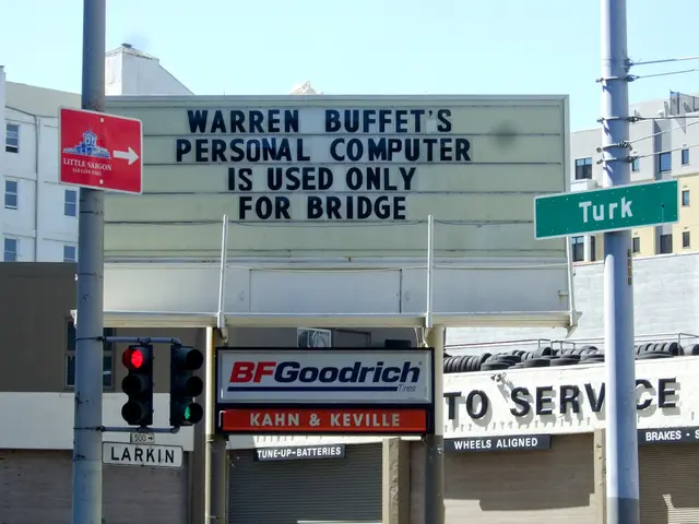 In this picture there are buildings with boards. On every board, there is some text. Towards the...